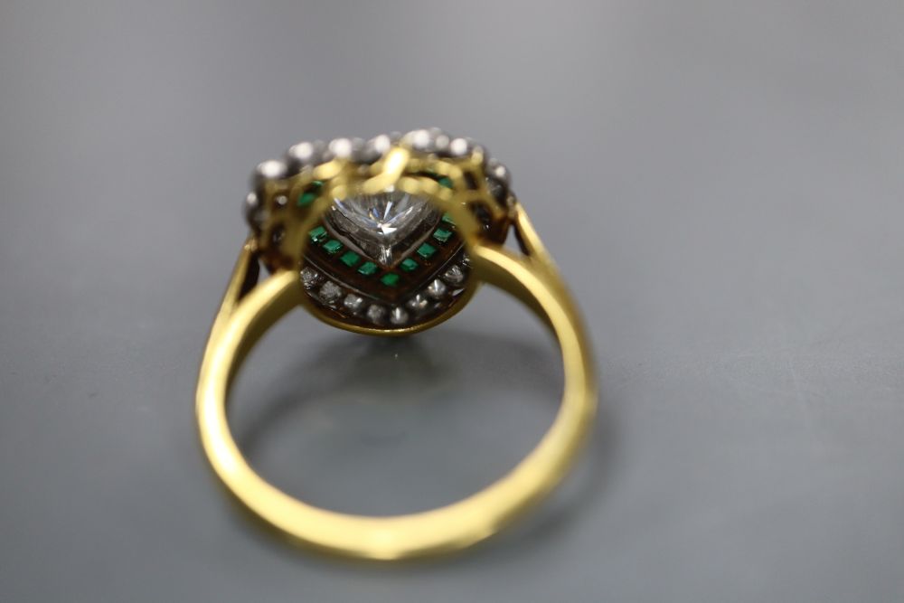 A modern 18ct gold, heart shaped diamond and emerald cluster set heart shaped dress ring, size N, gross 4.7 grams.